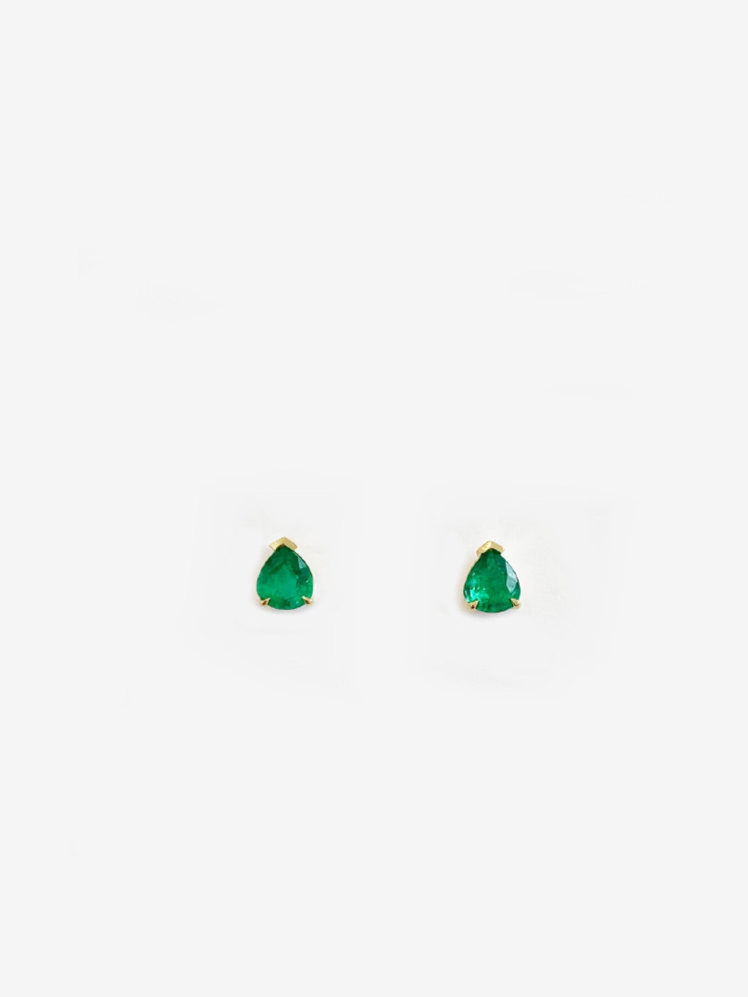 Pear Emerald Studs in Prongs